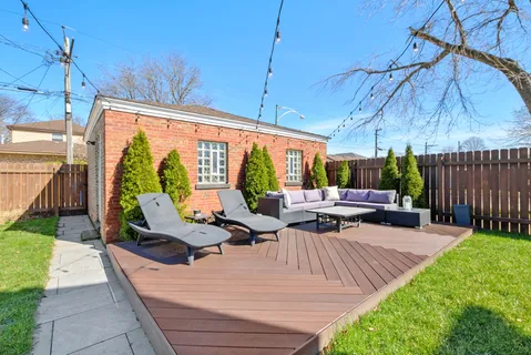 a view of backyard with sitting area