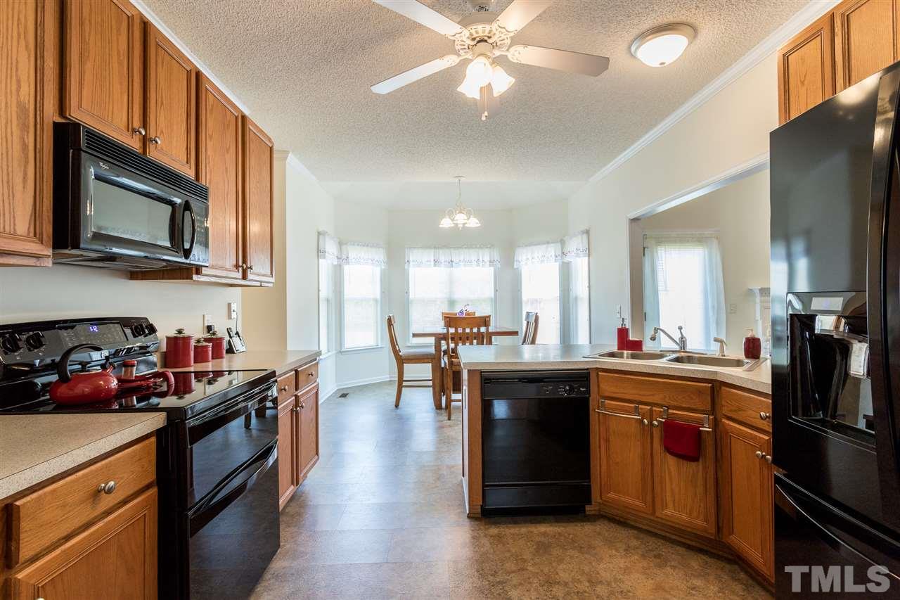 8509 Ridgebury Road Raleigh, NC 27603 - Photo 12 of 30 a kitchen with stainless steel appliances granite countertop a sink stove and refrigerator