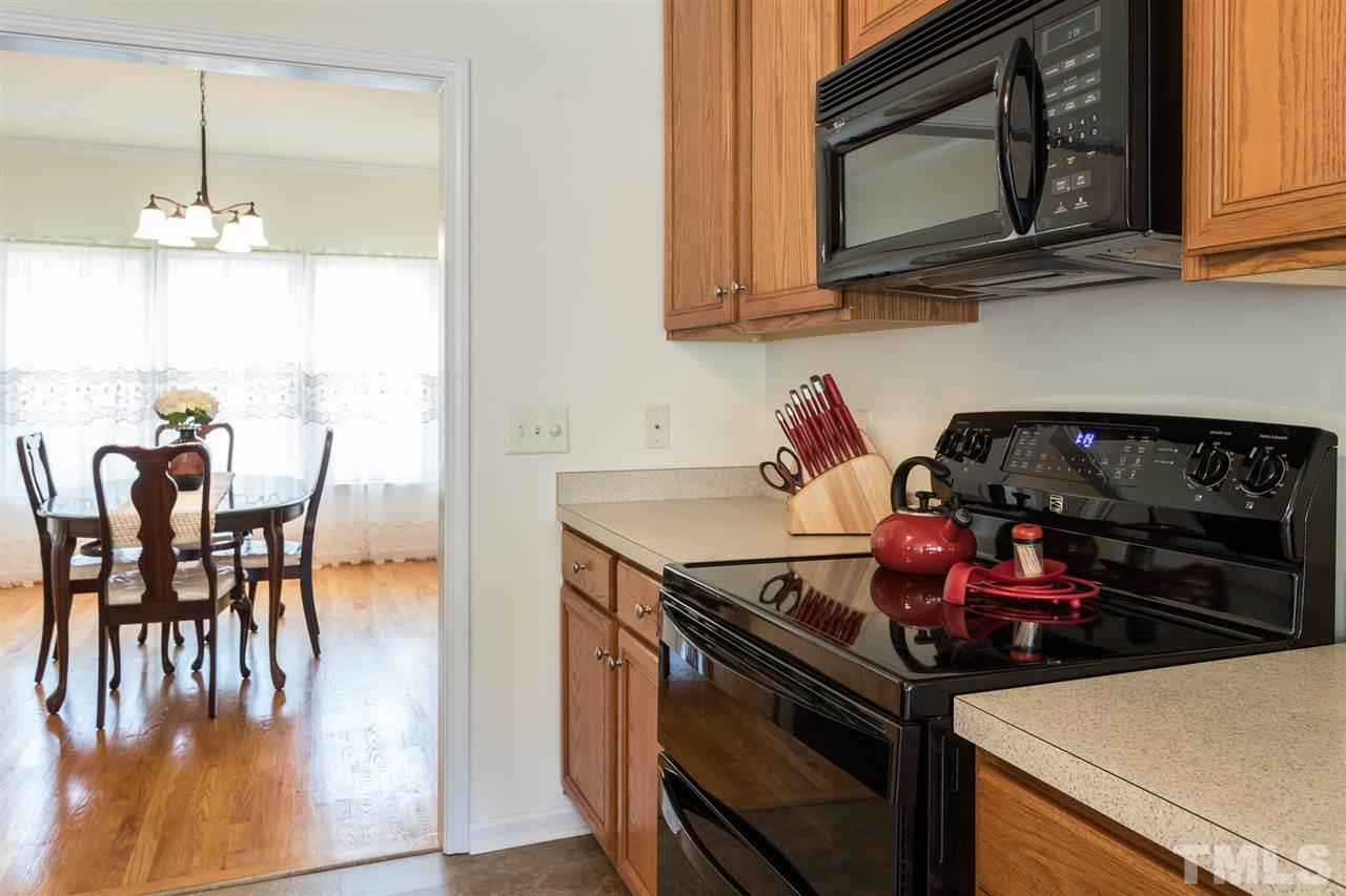 8509 Ridgebury Road Raleigh, NC 27603 - Photo 13 of 30 a kitchen with a stove and a microwave
