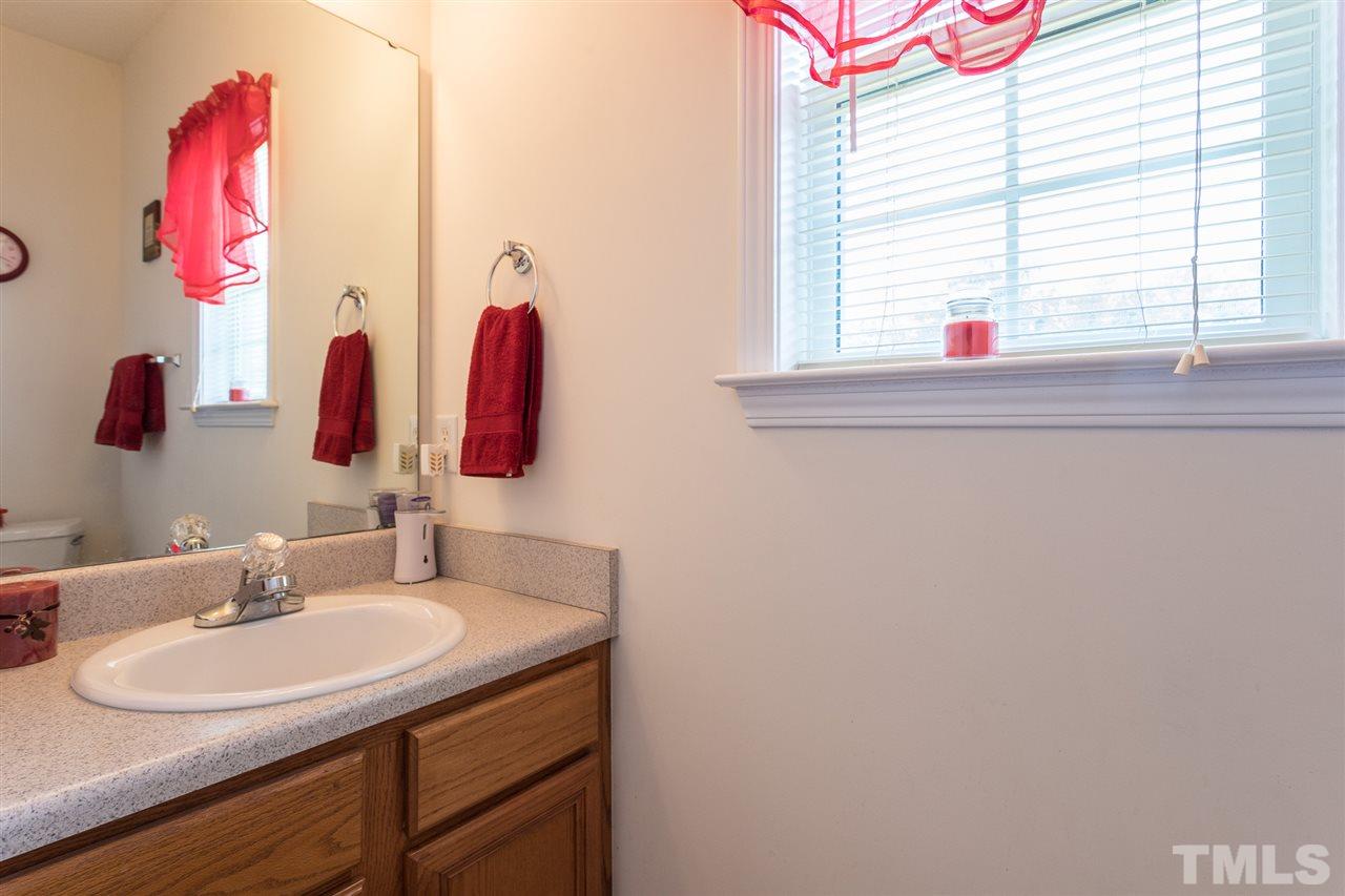 8509 Ridgebury Road Raleigh, NC 27603 - Photo 14 of 30 a bathroom with a sink and a mirror