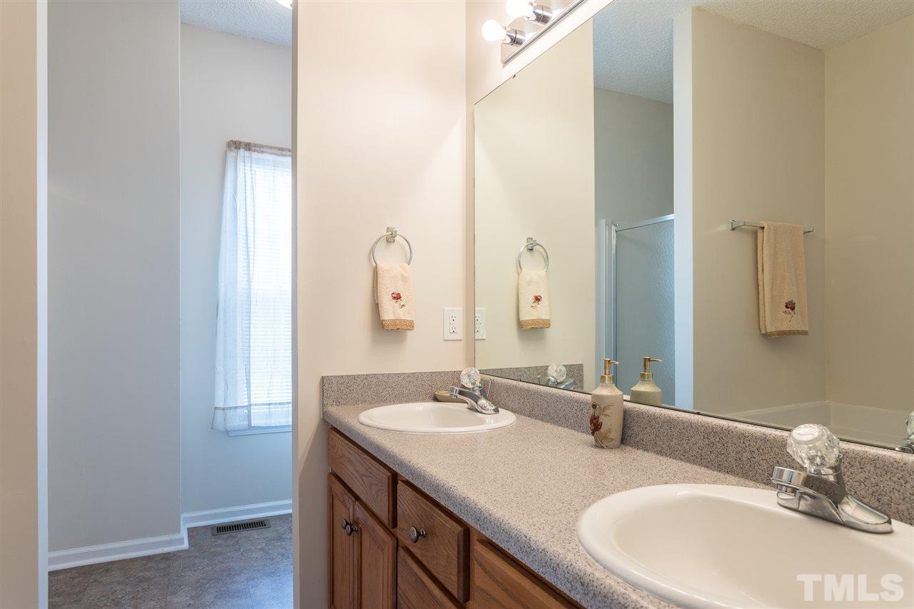 8509 Ridgebury Road Raleigh, NC 27603 - Photo 16 of 30 a bathroom with a sink and a mirror