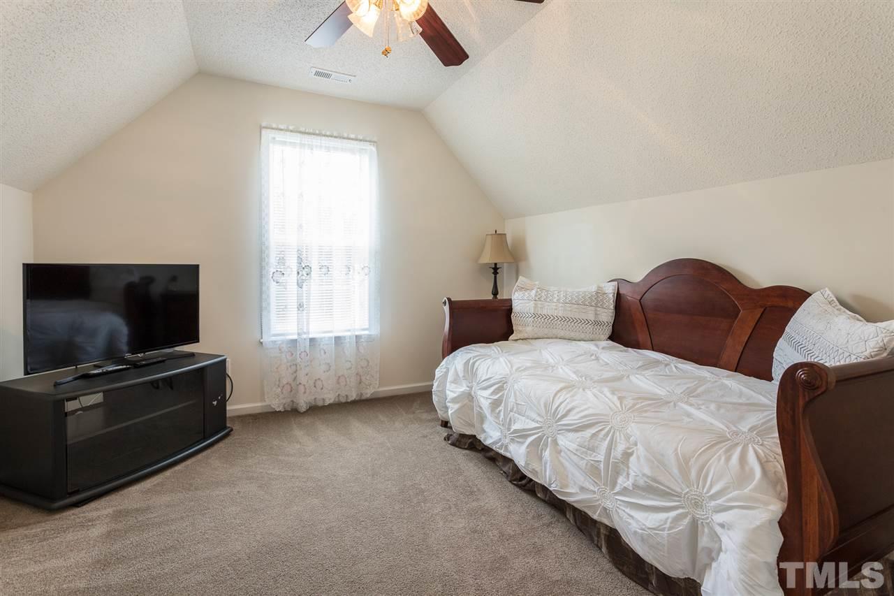 8509 Ridgebury Road Raleigh, NC 27603 - Photo 19 of 30 a bedroom with a bed and a flat screen tv