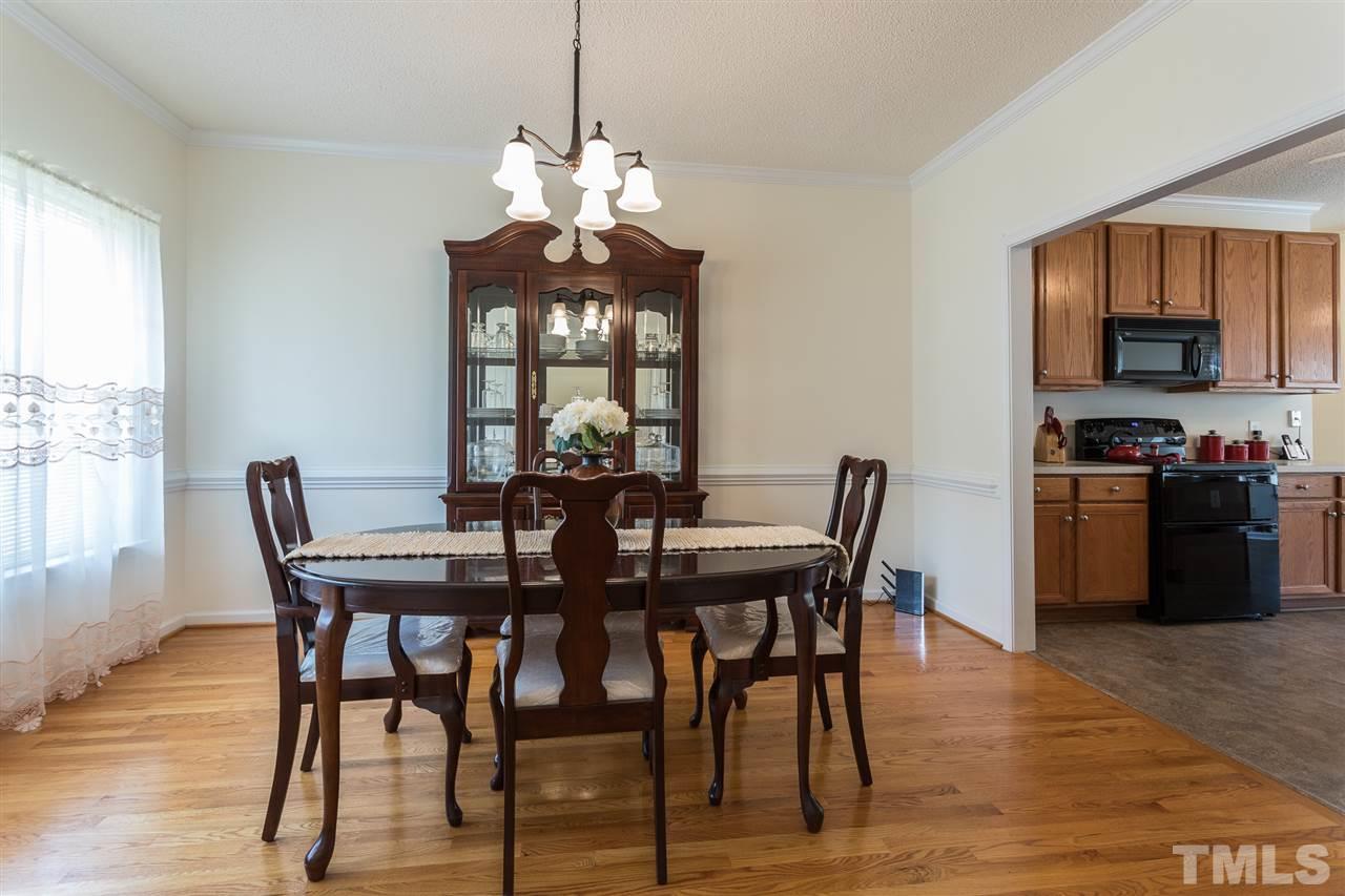 8509 Ridgebury Road Raleigh, NC 27603 - Photo 3 of 30 a view of a dining room with furniture window and wooden floor