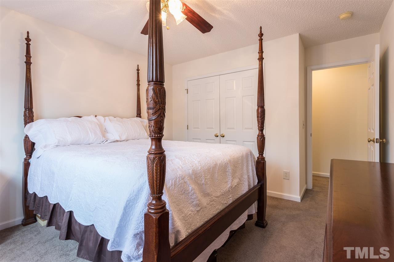 8509 Ridgebury Road Raleigh, NC 27603 - Photo 22 of 30 a bedroom with a bed window and a walk in closet