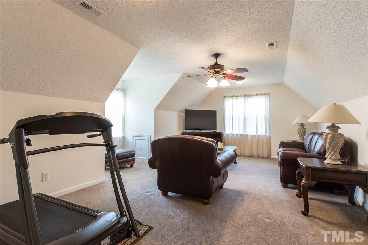 8509 Ridgebury Road Raleigh, NC 27603 - Photo 24 of 30 a living room with furniture and a chandelier