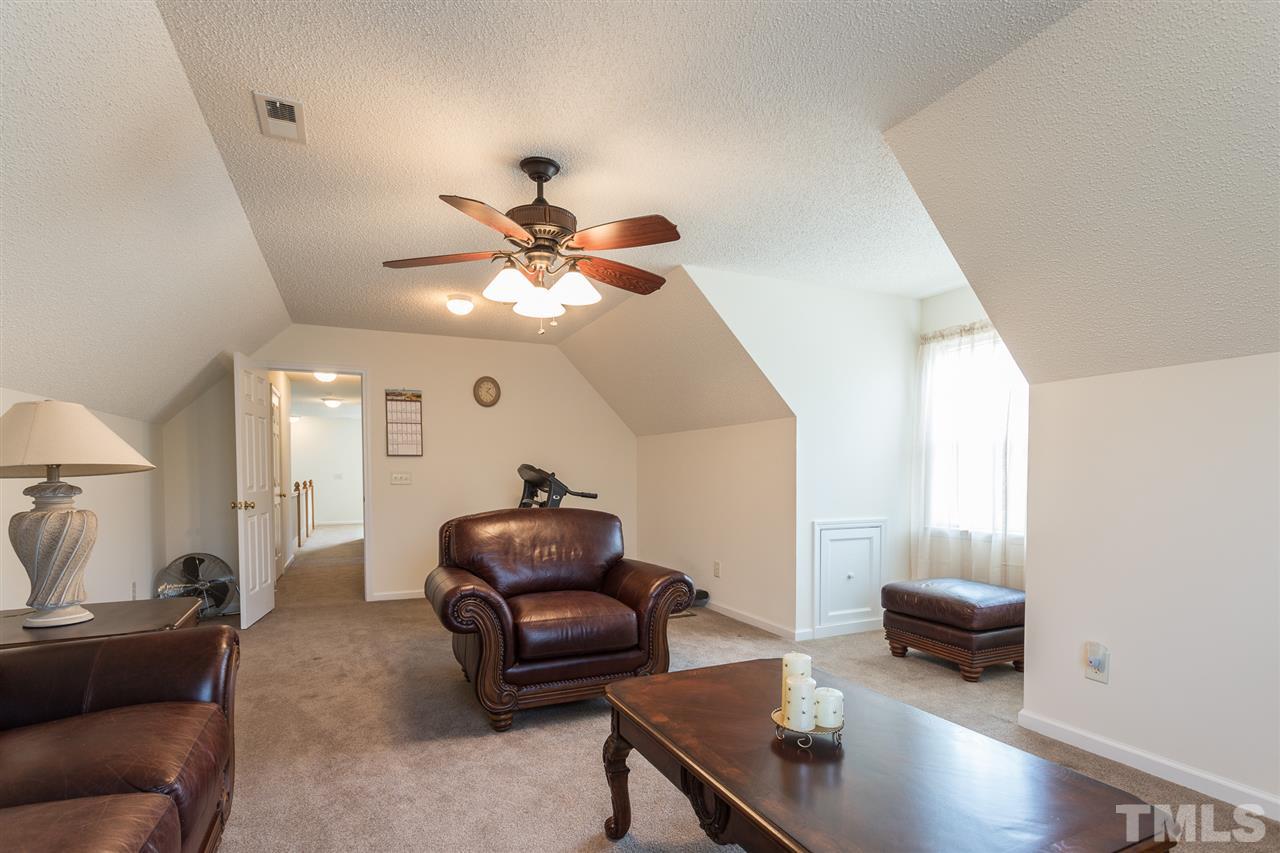8509 Ridgebury Road Raleigh, NC 27603 - Photo 25 of 30 a living room with furniture and a wooden floor
