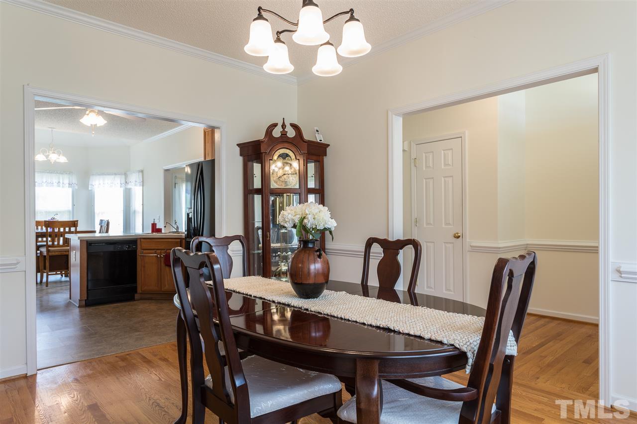 8509 Ridgebury Road Raleigh, NC 27603 - Photo 4 of 30 a view of a dining room with furniture and wooden floor