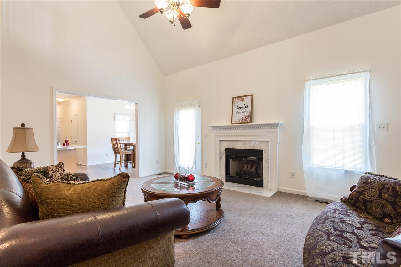 8509 Ridgebury Road Raleigh, NC 27603 - Photo 6 of 30 a living room with furniture and a fireplace