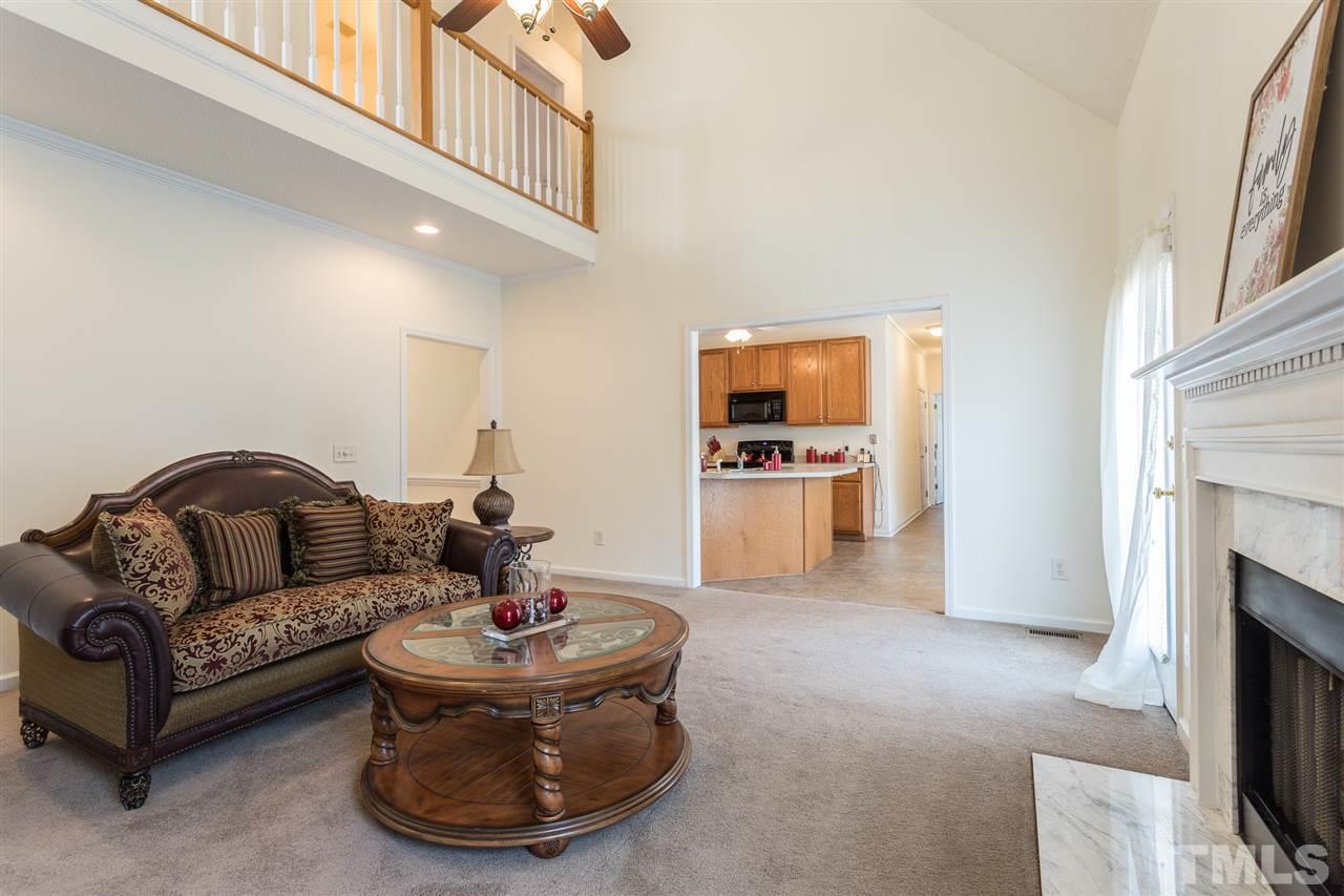 8509 Ridgebury Road Raleigh, NC 27603 - Photo 7 of 30 a living room with furniture and a fireplace