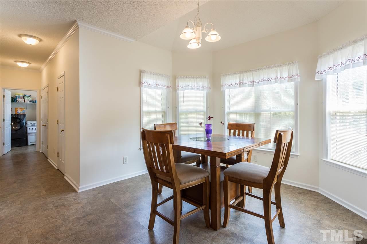 8509 Ridgebury Road Raleigh, NC 27603 - Photo 9 of 30 a view of a dining room with furniture and window