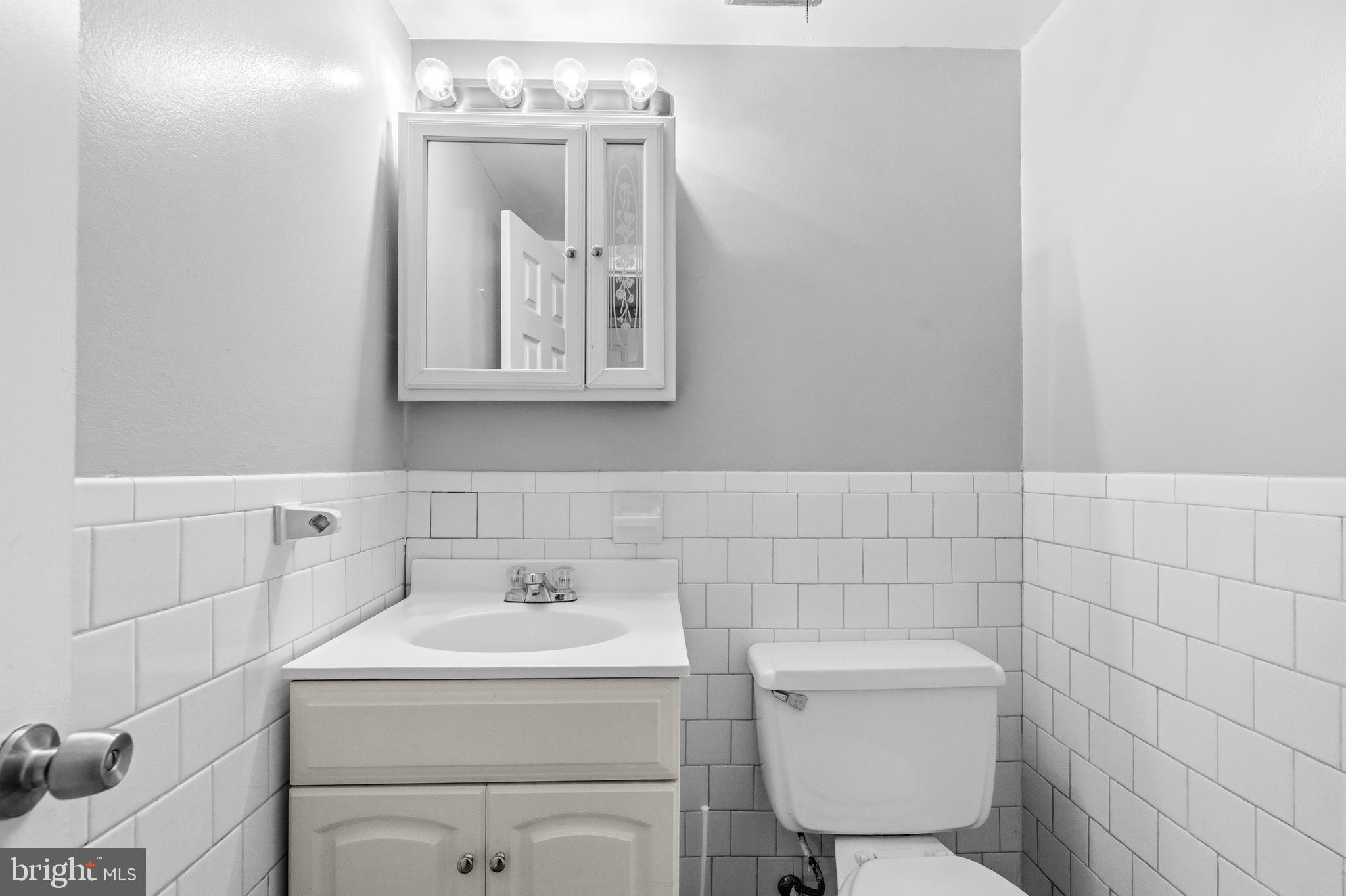 1983 Addison Road South District Heights, MD 20747 - Photo 18 of 32 a bathroom with a toilet sink and mirror