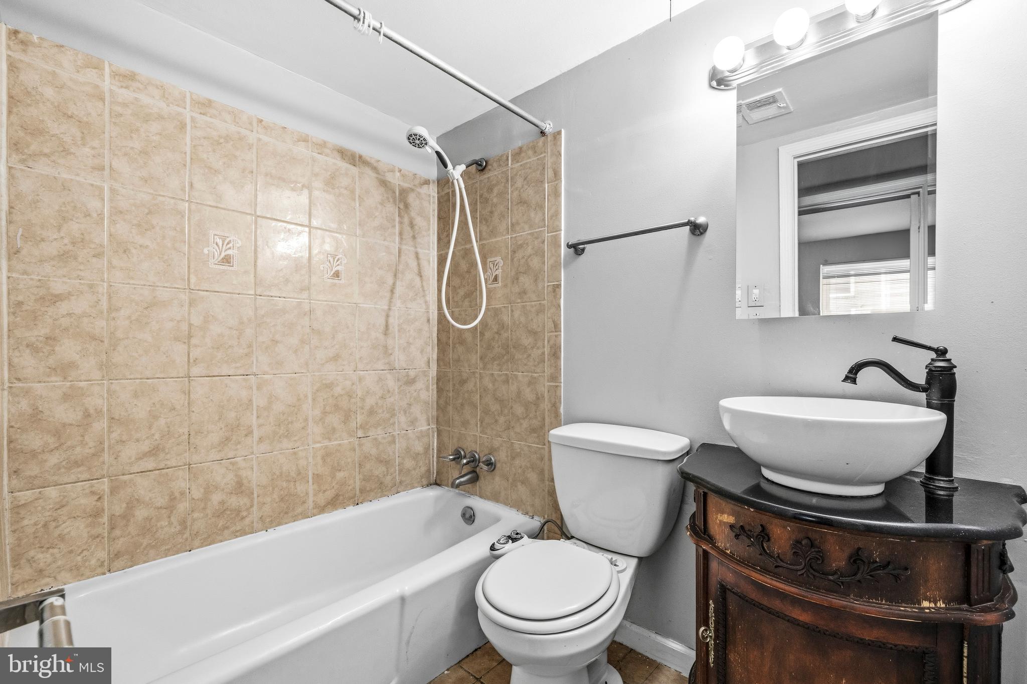 1983 Addison Road South District Heights, MD 20747 - Photo 28 of 32 a bathroom with a sink a toilet and a bathtub