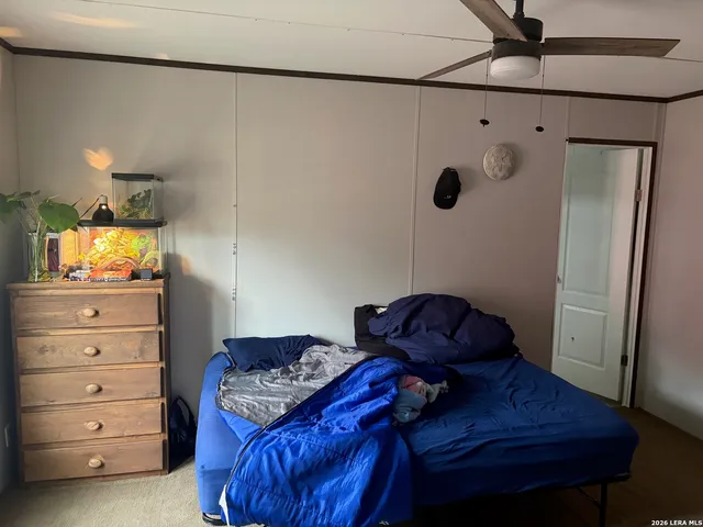 a bedroom with a bed and a mirror on the wall