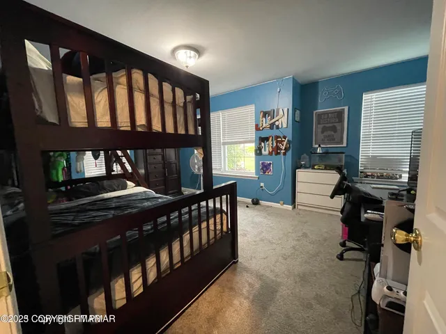 a bedroom with furniture and a window