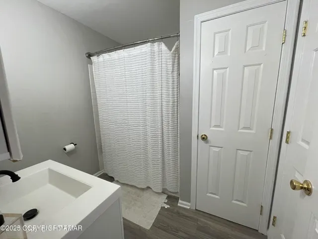 a bathroom with a sink and shower