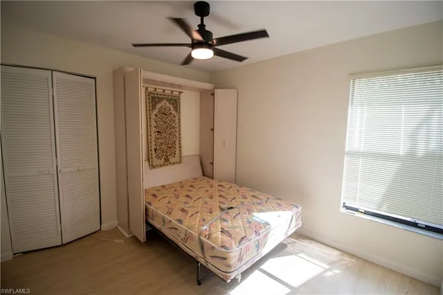 a view of a room with a ceiling fan and a window