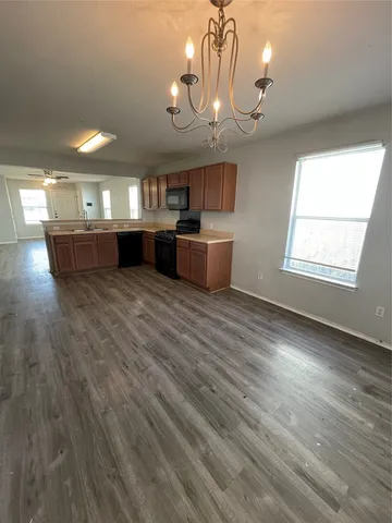a kitchen with granite countertop a stove and a sink