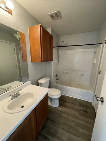 a view of a room with wooden floor and large windows