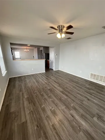 a kitchen with granite countertop a sink cabinets and stainless steel appliances