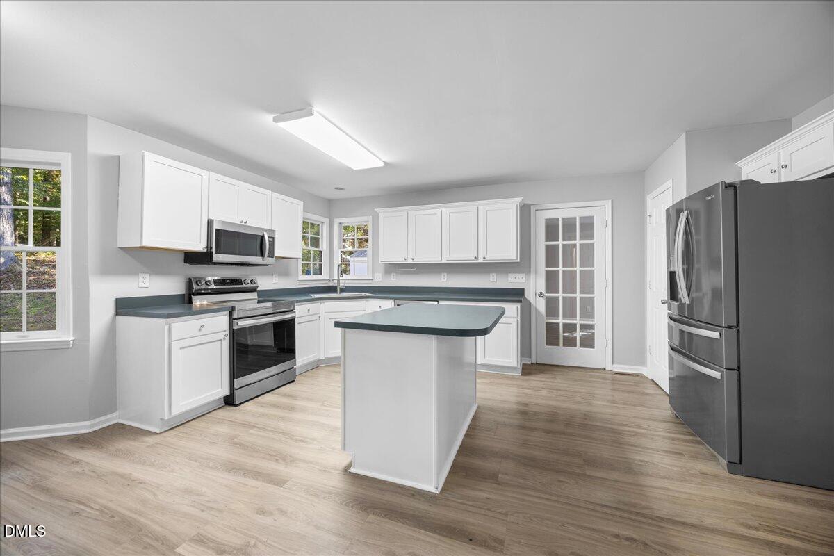 2708 Ferrand Drive Durham, NC 27705 - Photo 9 of 47 a kitchen with granite countertop a refrigerator stove top oven and sink