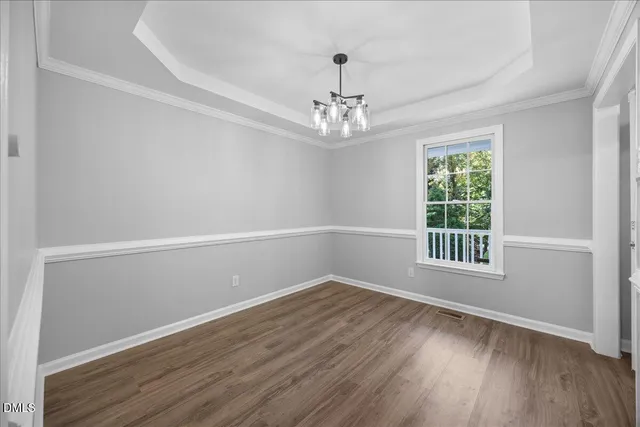 a kitchen with granite countertop a stove top oven a sink dishwasher a microwave oven with cabinets and wooden floor