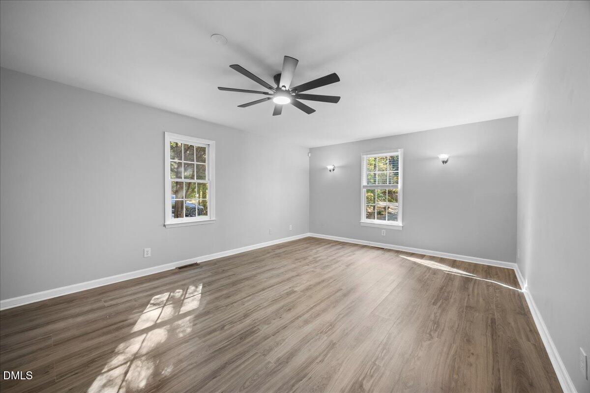 2708 Ferrand Drive Durham, NC 27705 - Photo 16 of 47 a view of empty room with wooden floor and fan