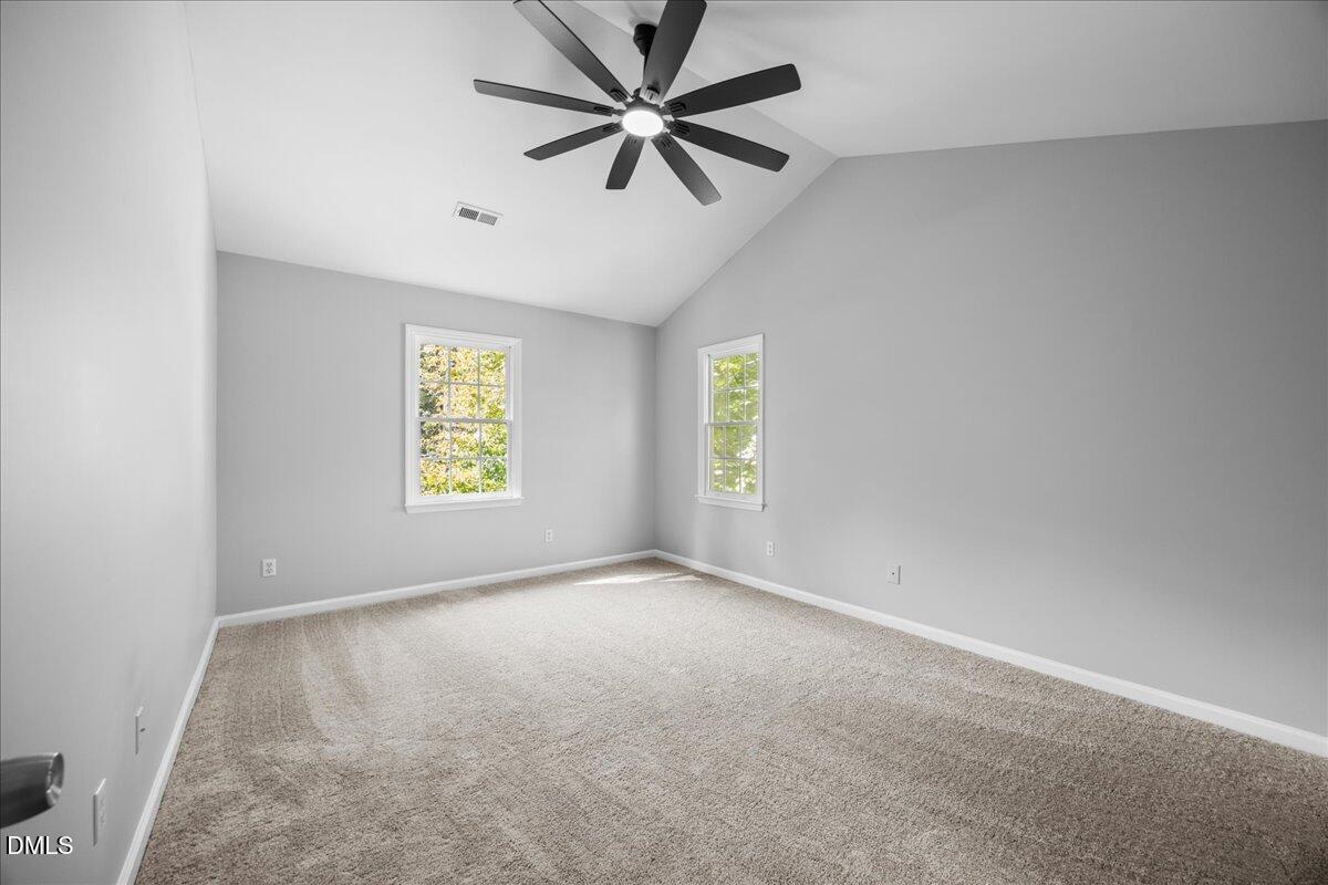 2708 Ferrand Drive Durham, NC 27705 - Photo 19 of 47 an empty room with windows and fan