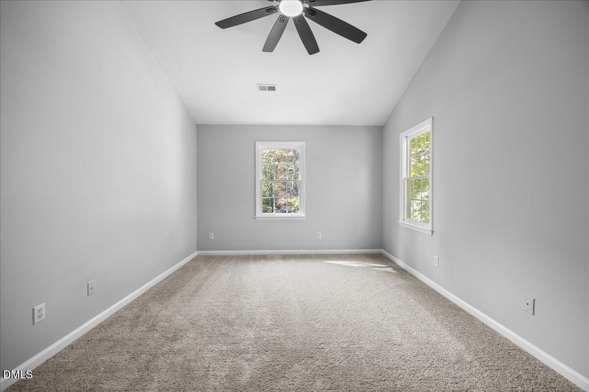 2708 Ferrand Drive Durham, NC 27705 - Photo 21 of 47 an empty room with a window and a ceiling fan