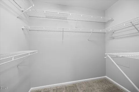 an empty room with fan and windows