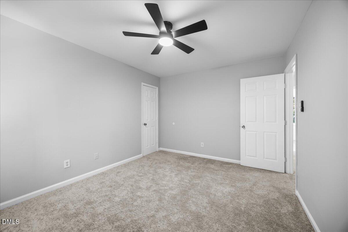 2708 Ferrand Drive Durham, NC 27705 - Photo 26 of 47 an empty room with closet and ceiling fan