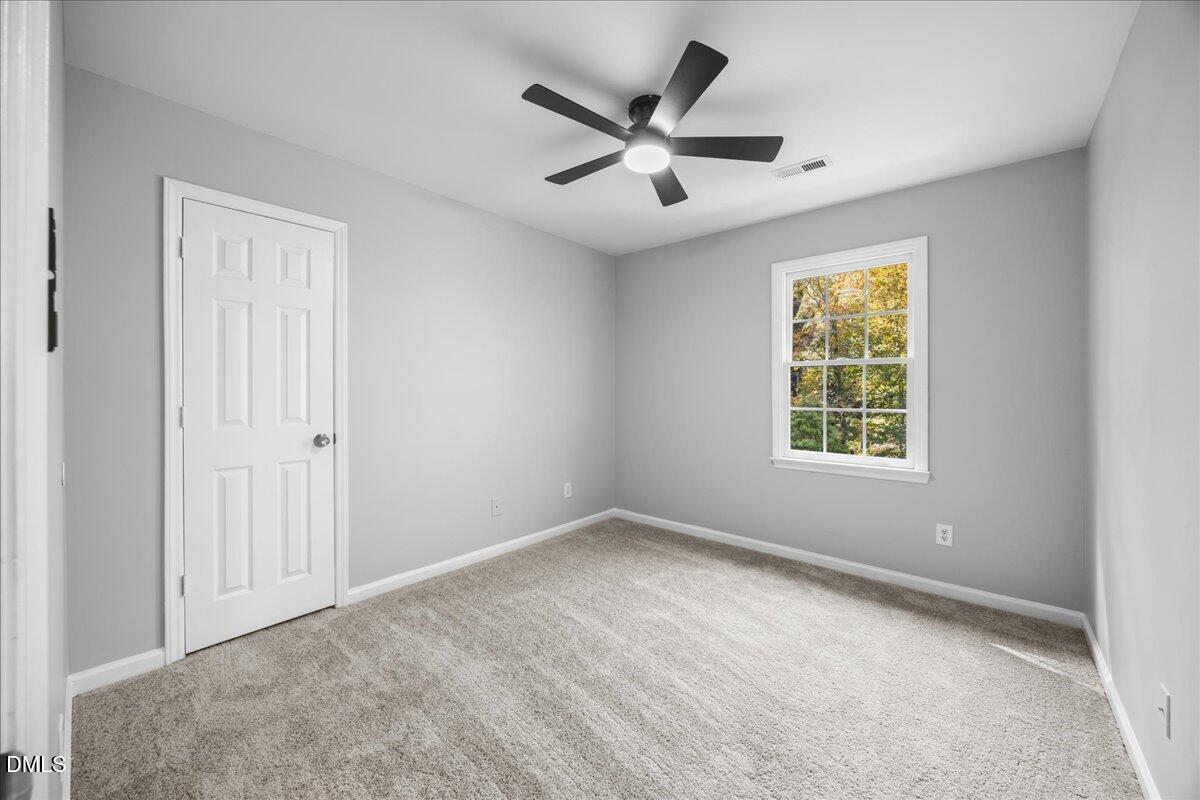 2708 Ferrand Drive Durham, NC 27705 - Photo 27 of 47 an empty room with ceiling fan and windows