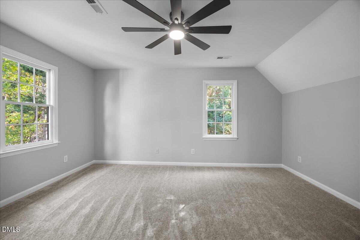 2708 Ferrand Drive Durham, NC 27705 - Photo 29 of 47 an empty room with windows and ceiling fan