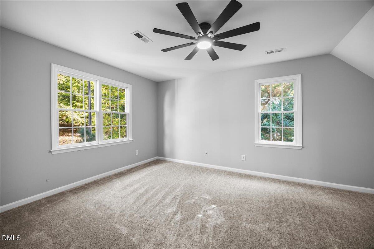2708 Ferrand Drive Durham, NC 27705 - Photo 30 of 47 a view of a big room with windows and chandelier fan