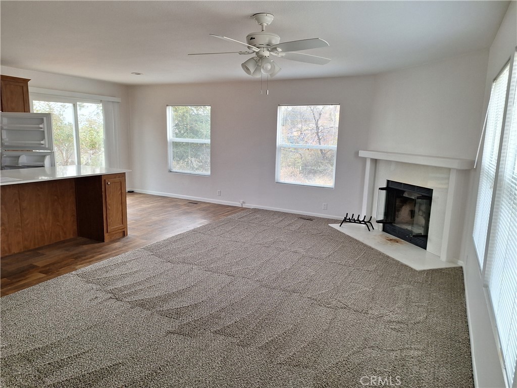 3708 Highway 140 Mariposa, CA 95338 - Photo 5 of 19 wooden floor fireplace and windows in an empty room