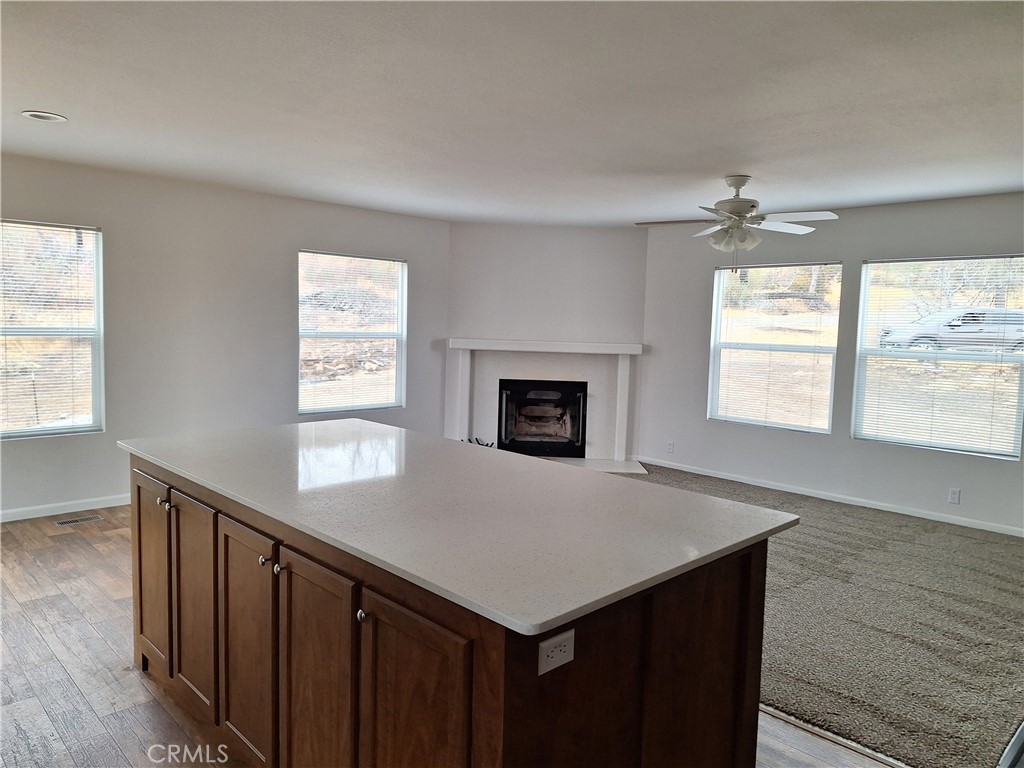 3708 Highway 140 Mariposa, CA 95338 - Photo 7 of 19 an empty room with windows and fireplace