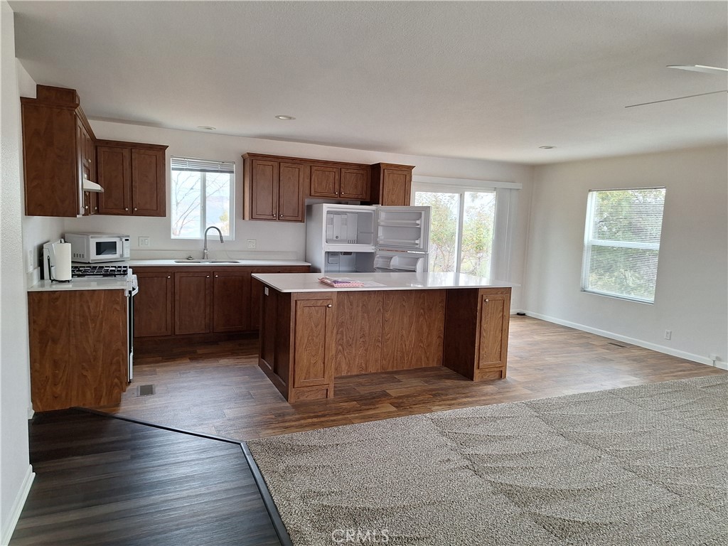 3708 Highway 140 Mariposa, CA 95338 - Photo 8 of 19 a kitchen with stainless steel appliances granite countertop a stove a sink dishwasher and a refrigerator