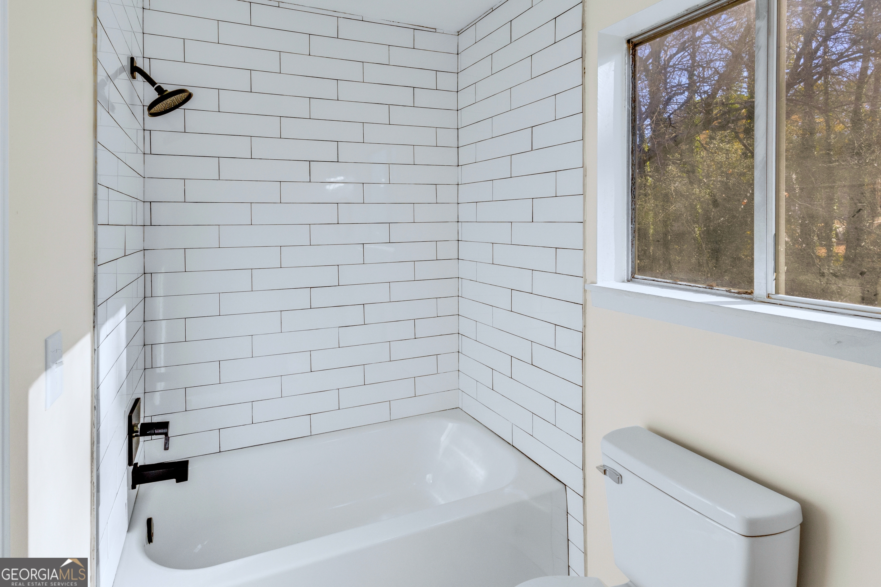 6695 Cedar Hurst Trail Atlanta, GA 30349 - Photo 12 of 23 a bathroom with a bathtub