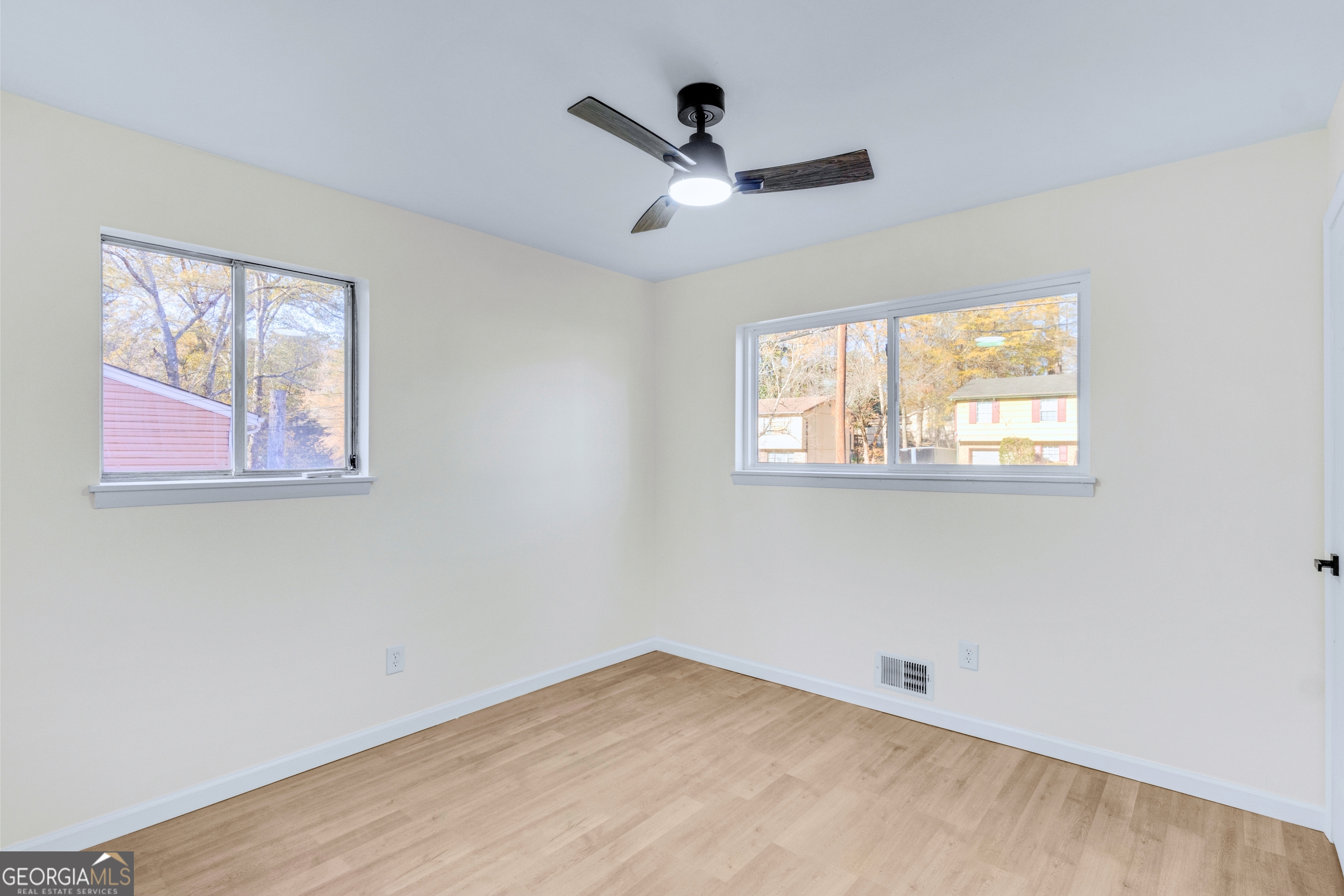 6695 Cedar Hurst Trail Atlanta, GA 30349 - Photo 14 of 23 a view of empty room with wooden floor and fan