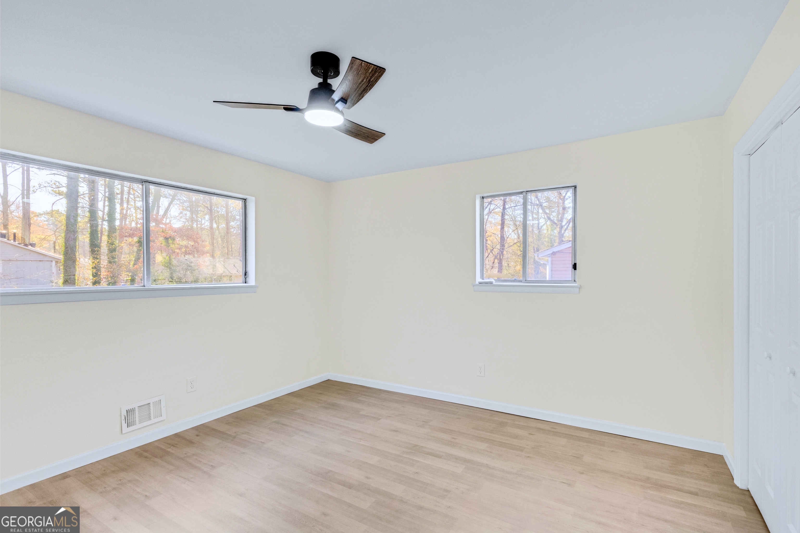 6695 Cedar Hurst Trail Atlanta, GA 30349 - Photo 15 of 23 a view of an empty room with a window and a ceiling fan