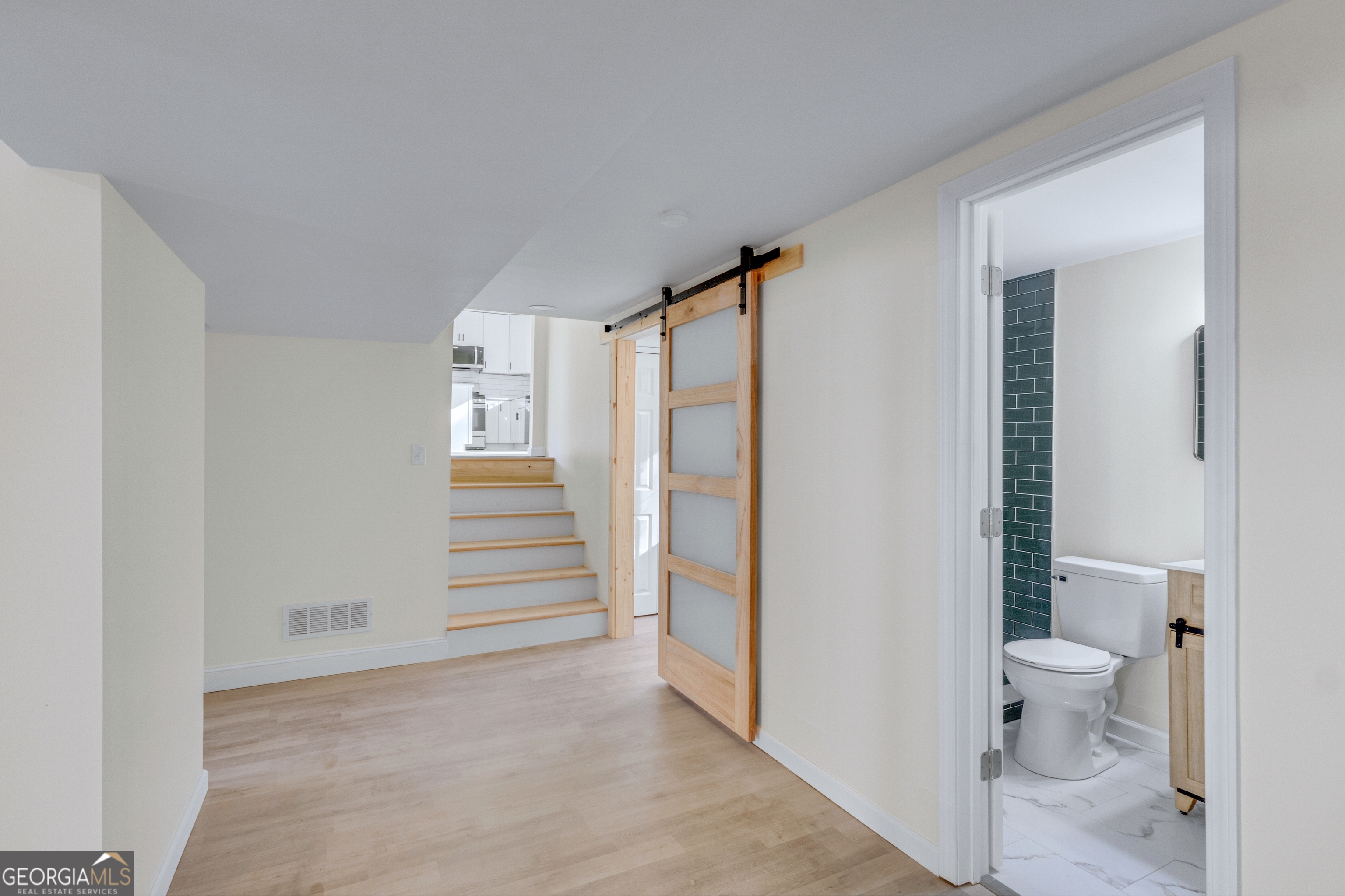 6695 Cedar Hurst Trail Atlanta, GA 30349 - Photo 17 of 23 a bathroom with a toilet and a shower