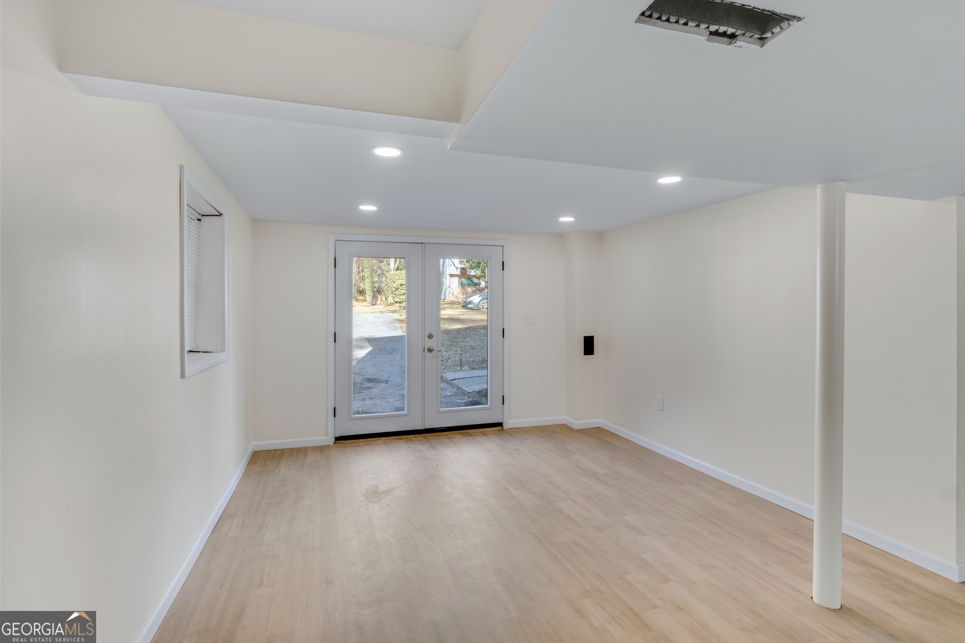 6695 Cedar Hurst Trail Atlanta, GA 30349 - Photo 20 of 23 a view of an empty room with wooden floor and windows
