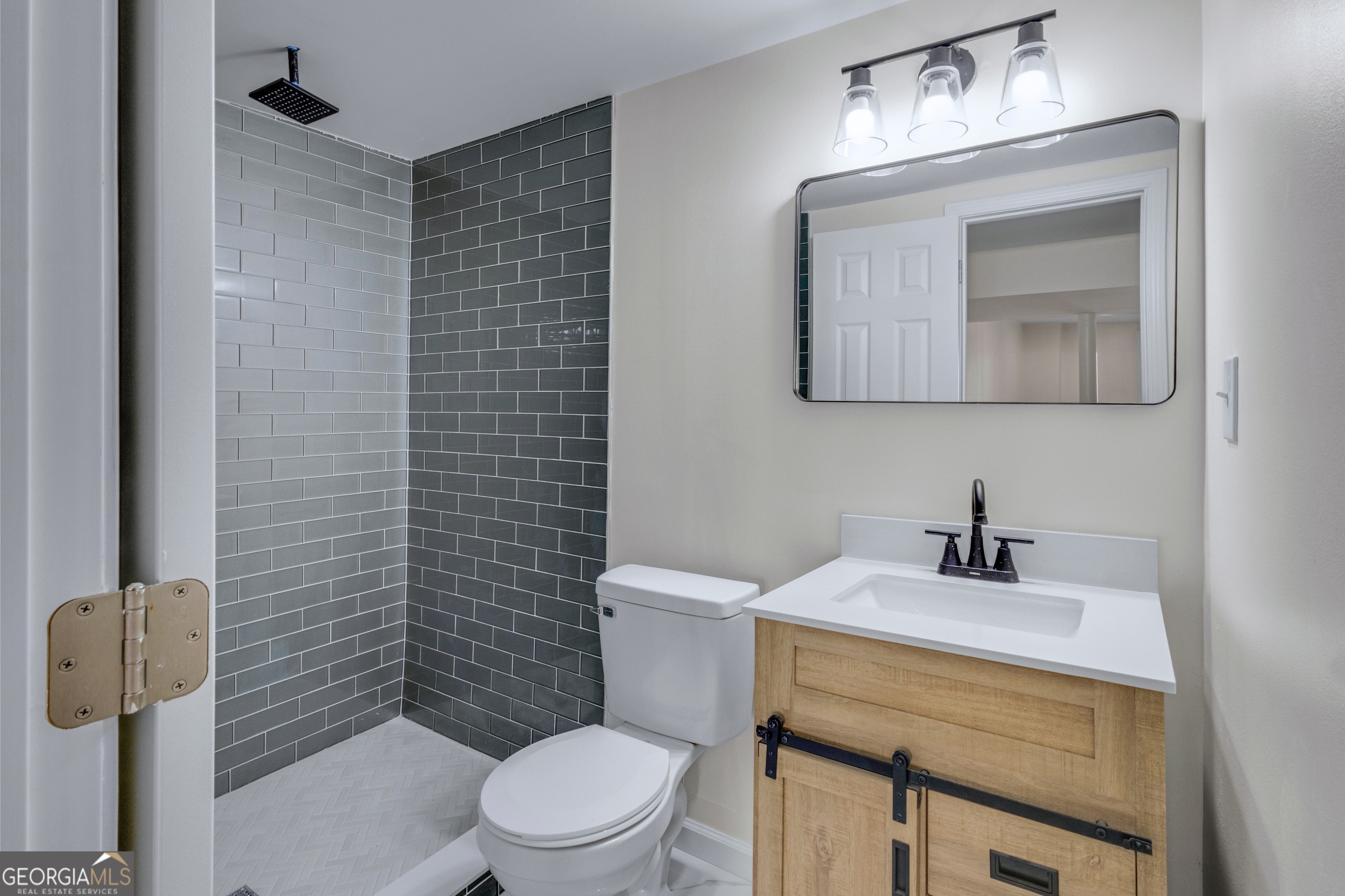 6695 Cedar Hurst Trail Atlanta, GA 30349 - Photo 21 of 23 a bathroom with a sink a toilet and mirror