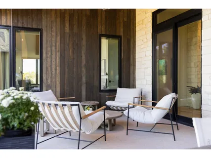 a view of a patio with table and chairs and potted plants