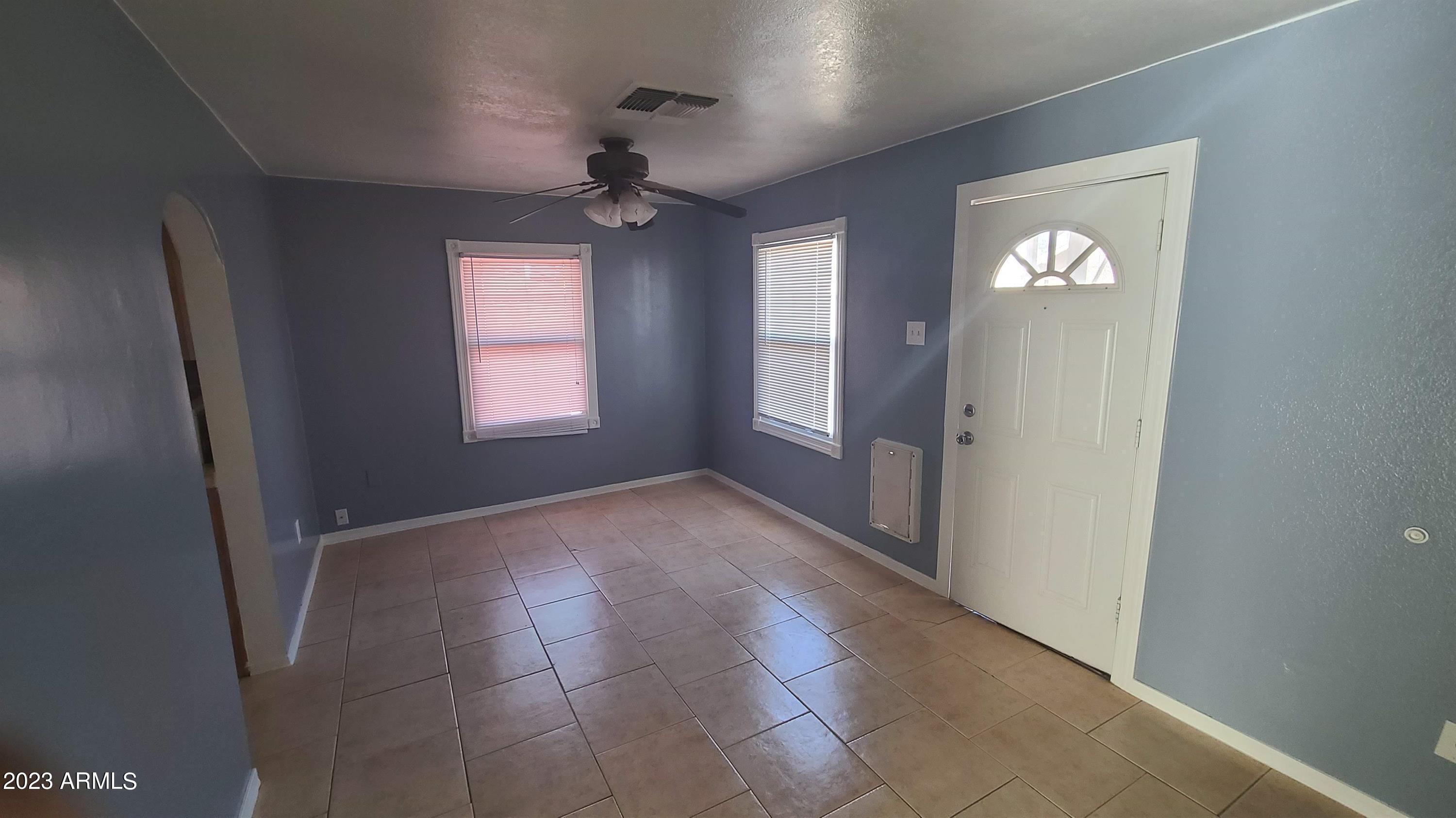 1221 East Roosevelt Street, Unit B Phoenix, AZ 85006 - Photo 2 of 5 an empty room with windows and entrance