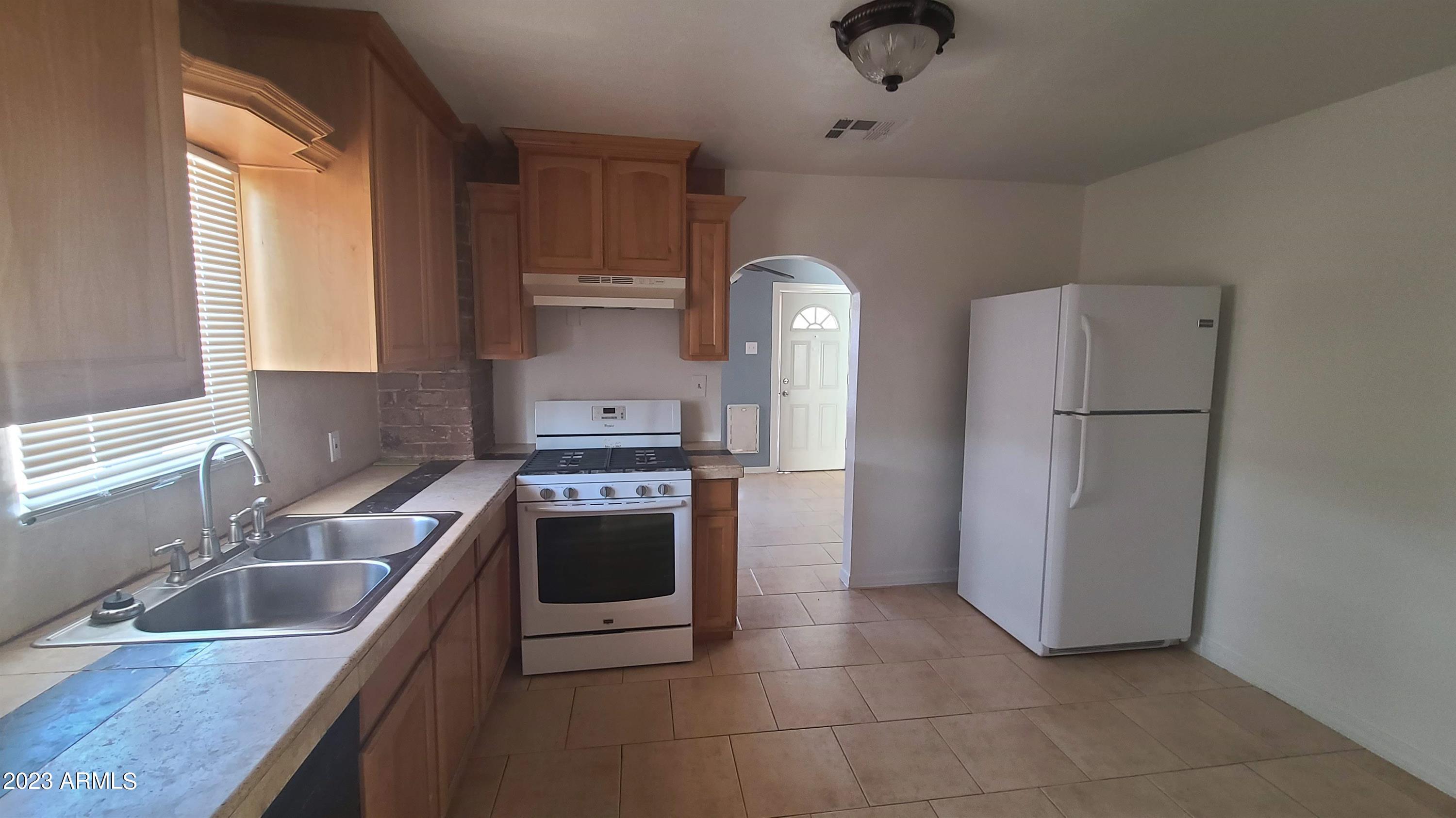 1221 East Roosevelt Street, Unit B Phoenix, AZ 85006 - Photo 4 of 5 a kitchen with a refrigerator sink and stove