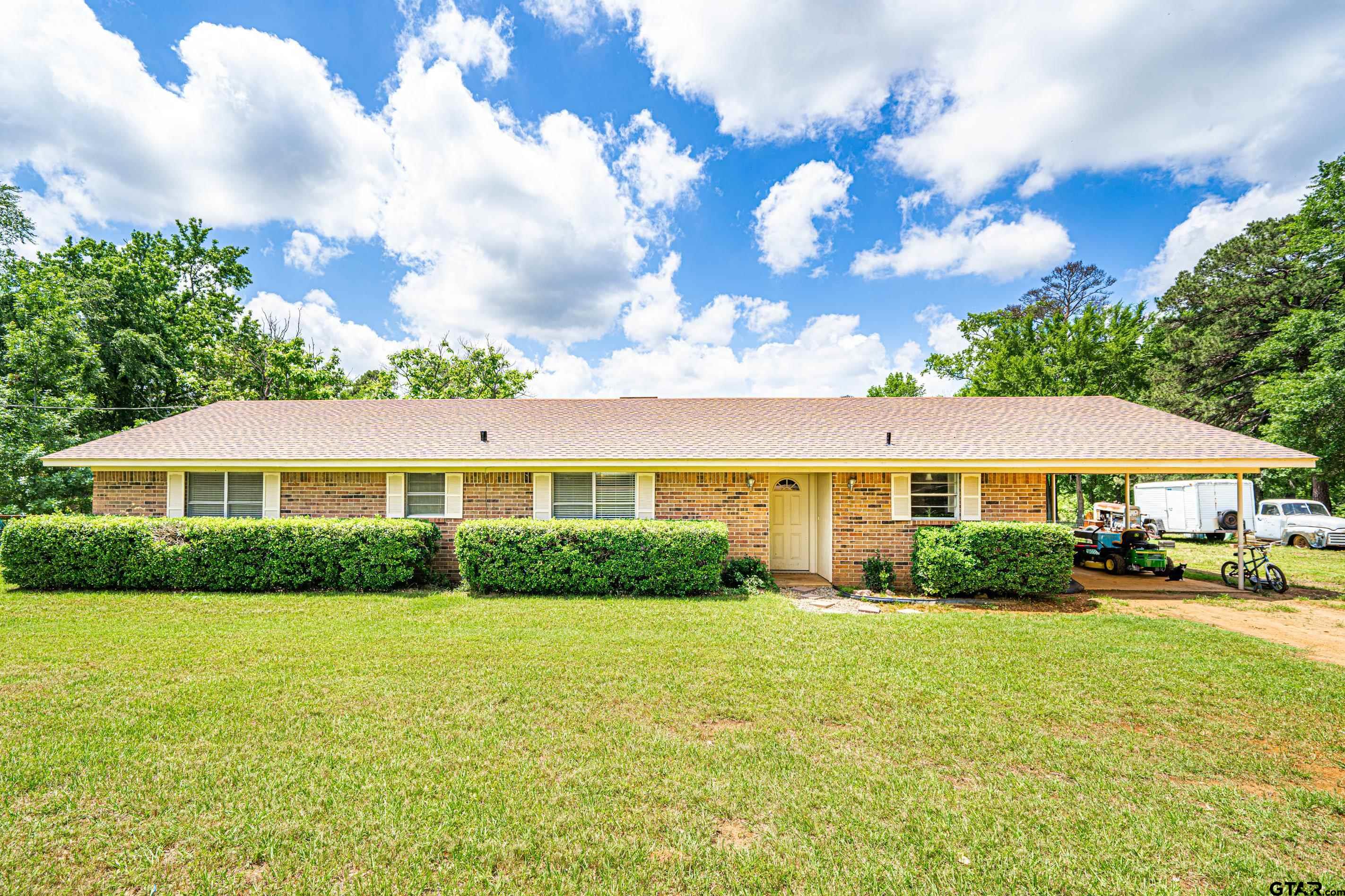 2536 Elk Road Gilmer, TX 75644 - Photo 1 of 32 a view of a big house with a big yard and potted plants