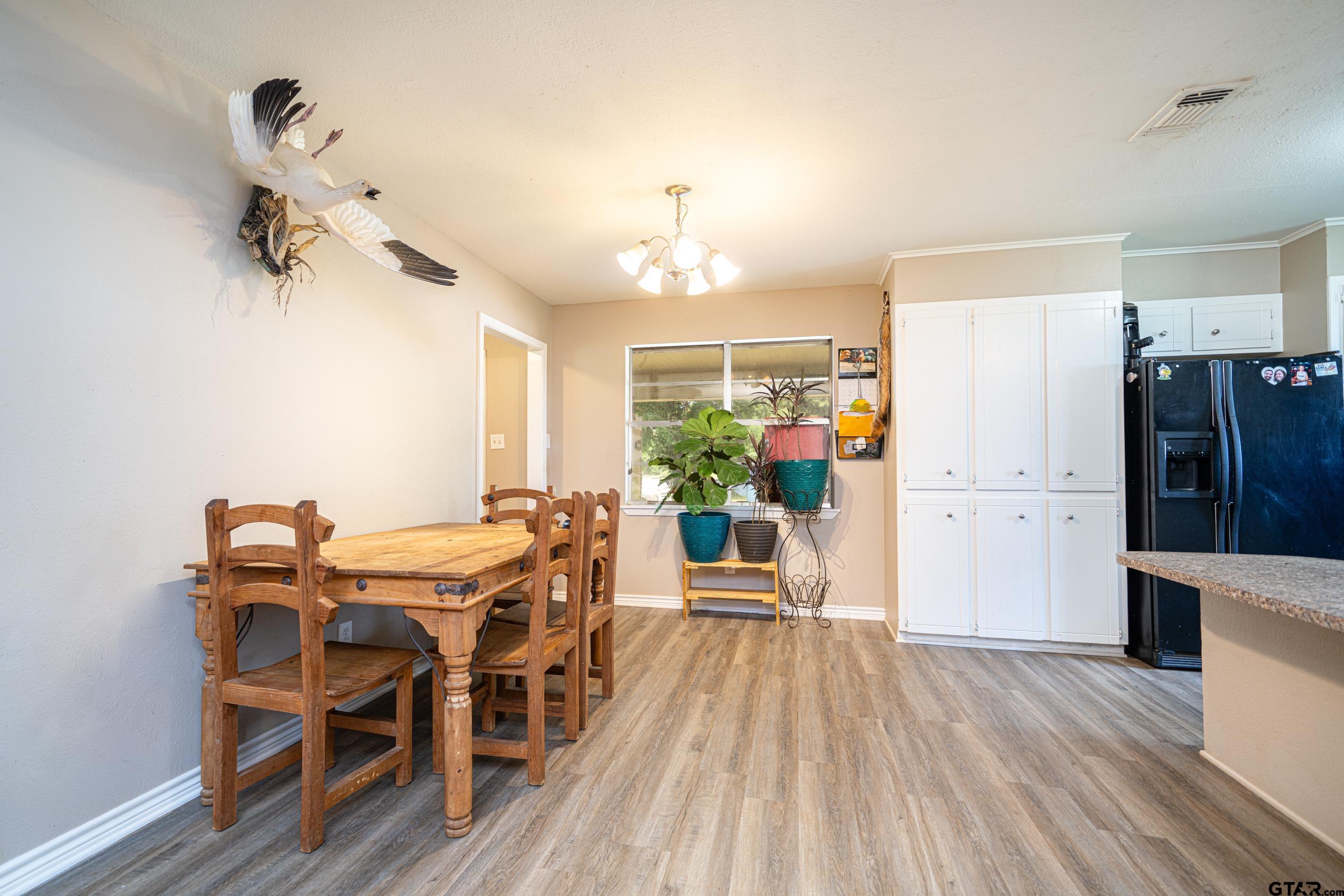 2536 Elk Road Gilmer, TX 75644 - Photo 12 of 32 a view of a dining room with furniture window and wooden floor