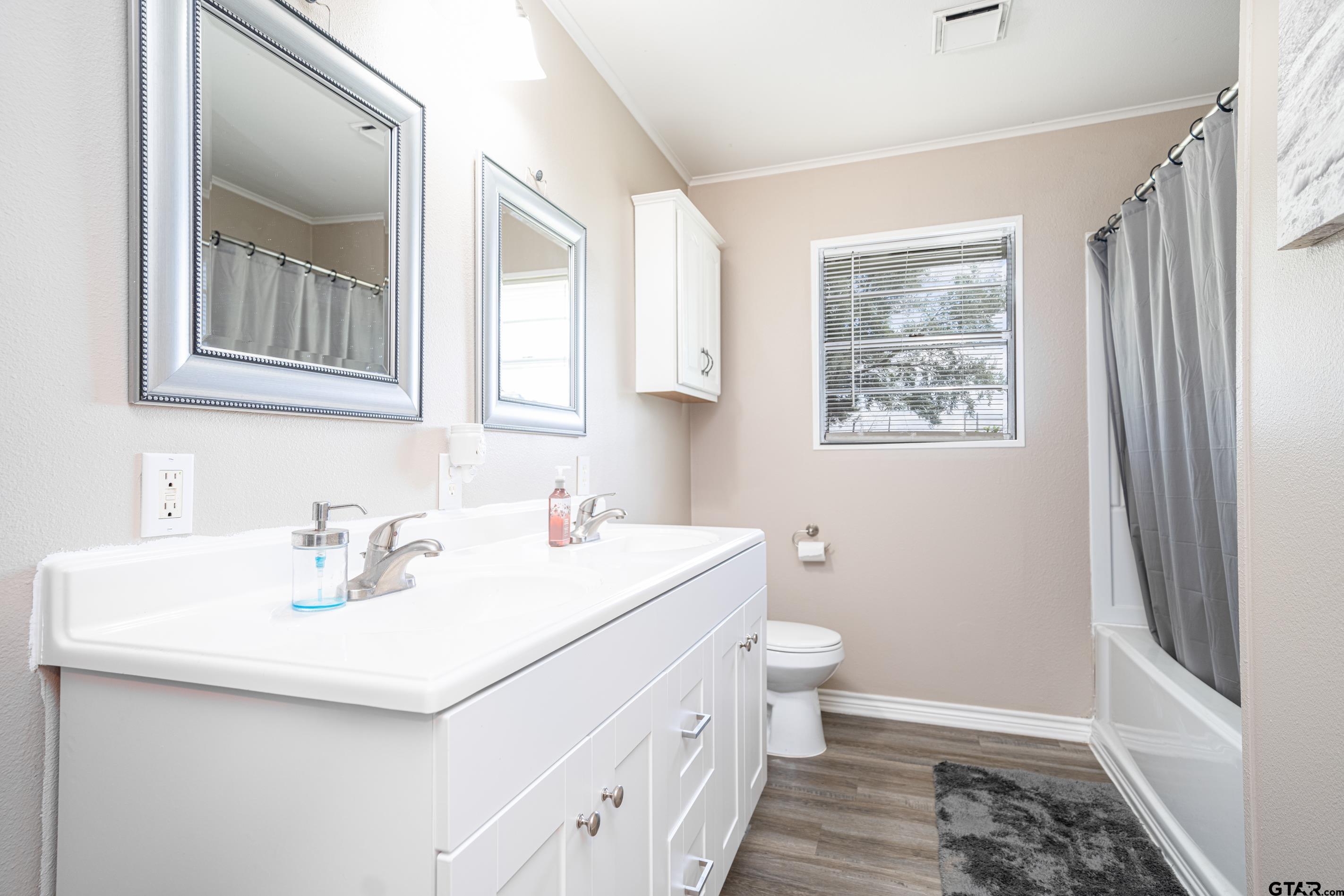 2536 Elk Road Gilmer, TX 75644 - Photo 14 of 32 a bathroom with a sink toilet and vanity