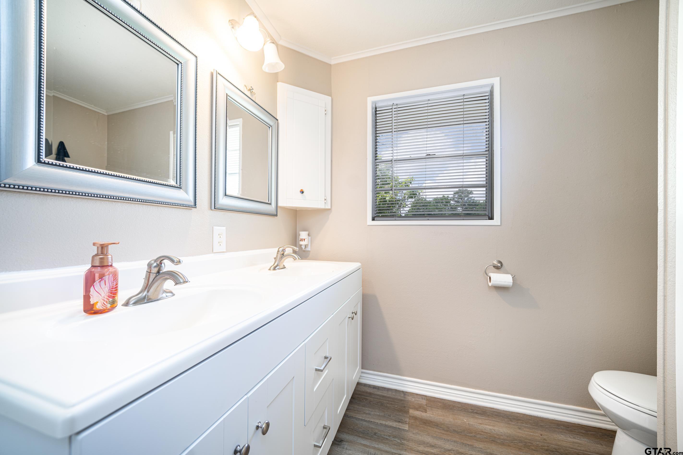 2536 Elk Road Gilmer, TX 75644 - Photo 17 of 32 a bathroom with a sink and a mirror