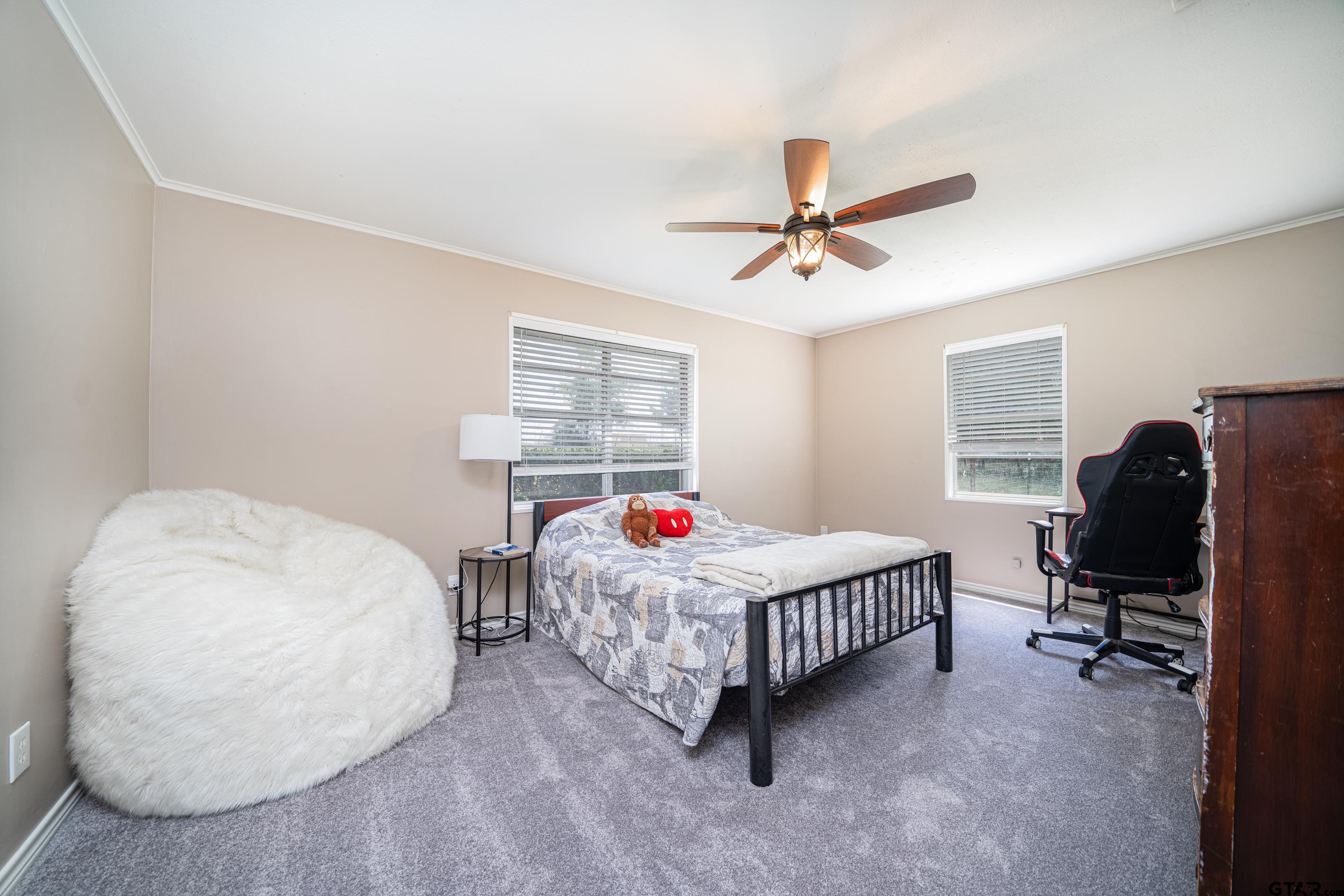 2536 Elk Road Gilmer, TX 75644 - Photo 19 of 32 a bedroom with a bed a desk and chair